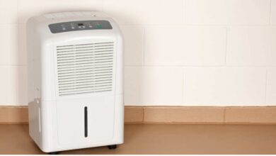 a white dehumidifiers on toscana color floor with white background wall | best dehumidifier for basement