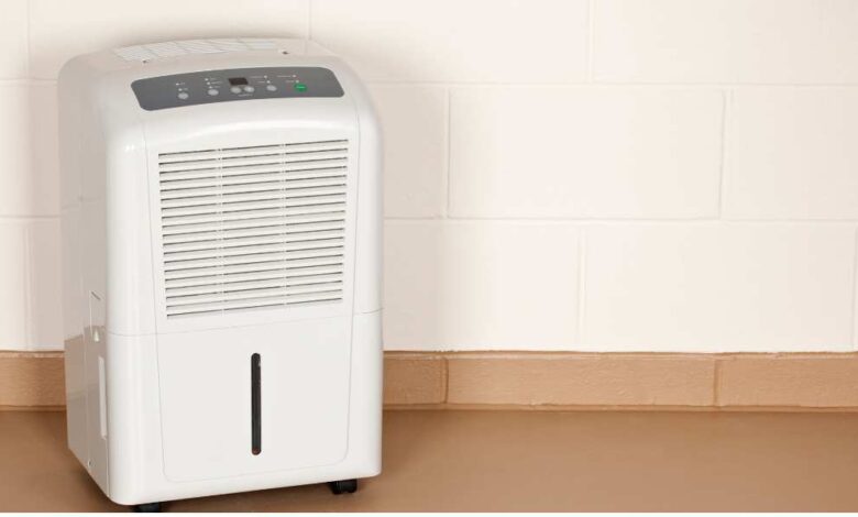 a white dehumidifiers on toscana color floor with white background wall | best dehumidifier for basement