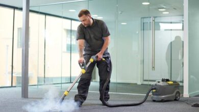 a man in black t-shirt and black pant using steam cleaner on the floor | best floor steam cleaners