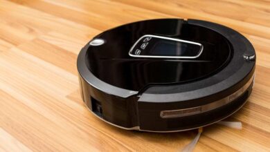 a black robot vacuum lying on the floor
