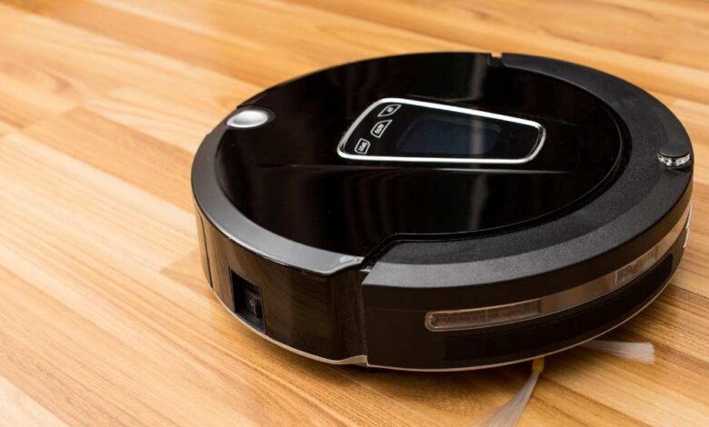 a black robot vacuum lying on the floor
