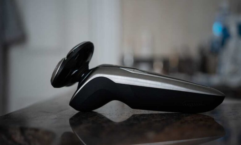 a Black Philips shaver on wooden table
