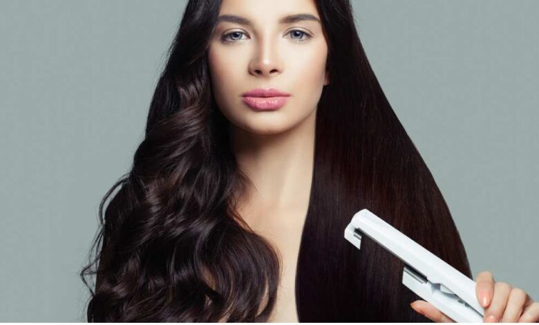 A girl using Straightener in her curly hiar, looking at camera | best hair straightener for curly hair