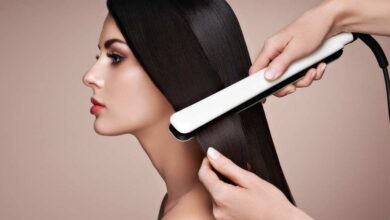 A person straightening girl hair with white color Corioliss C3 straightener