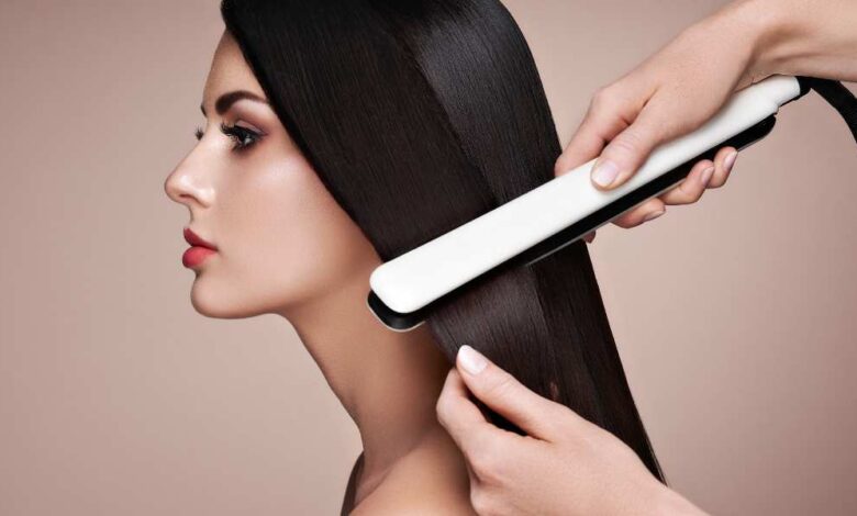 A person straightening girl hair with white color Corioliss C3 straightener