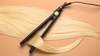 A black ghd platinum+ straightening golden colored hair