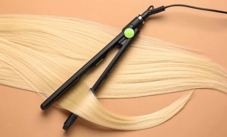 A black ghd platinum+ straightening golden colored hair