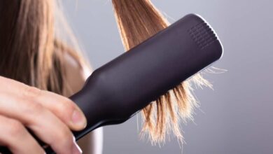 A girl using Ghd guild straightening brush in her hair | GHD straightening brush