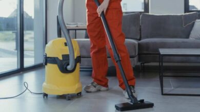a person in orange pant using yellow color hot ash vacuum cleaner